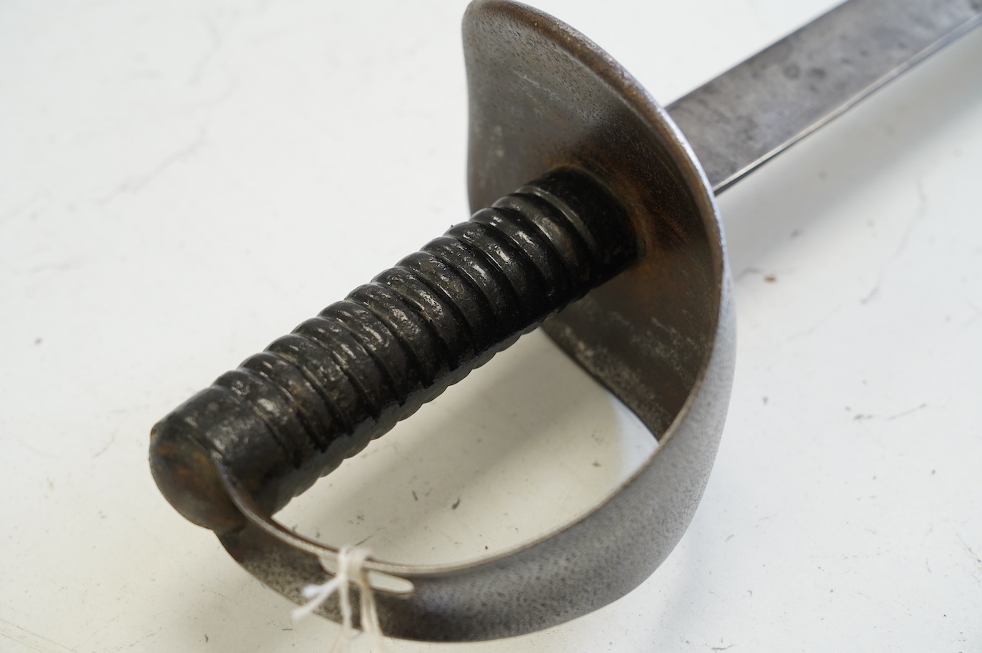 A naval boarding cutlass, blade with issue stamps, 1892, iron guard (pitted) and ribbed iron grips, blade 70.5cm. Condition - worn